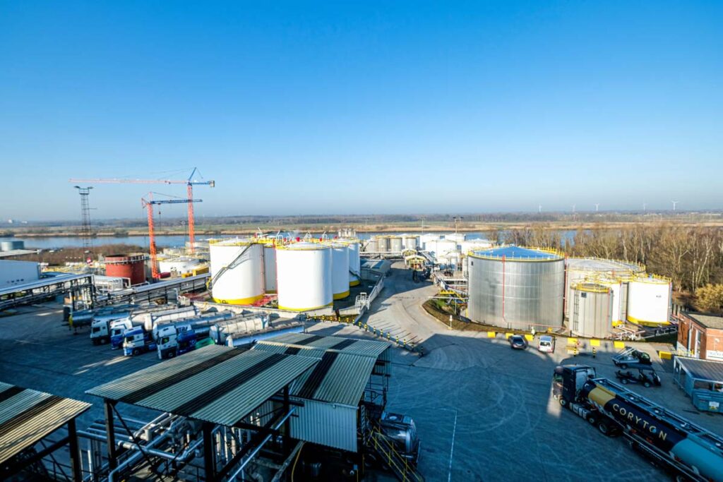 Aerial view of Tank Storage Verbeke with storage tanks, trucks, and cranes, featuring multimodal access via water, road, and rail